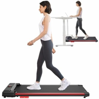 Woman walking on a treadmill with a standing desk in the background.